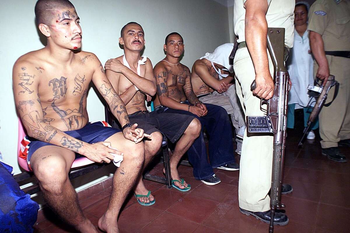 Injured prison gang members wait for medical aid at a local hospital in Santa Ana, El Salvador, after a gang fight broke out at the penitentiary Centro Penal de Apanteos. Two people were reported dead. Keep clicking to learn more about deadly prison gangs here in the U.S.