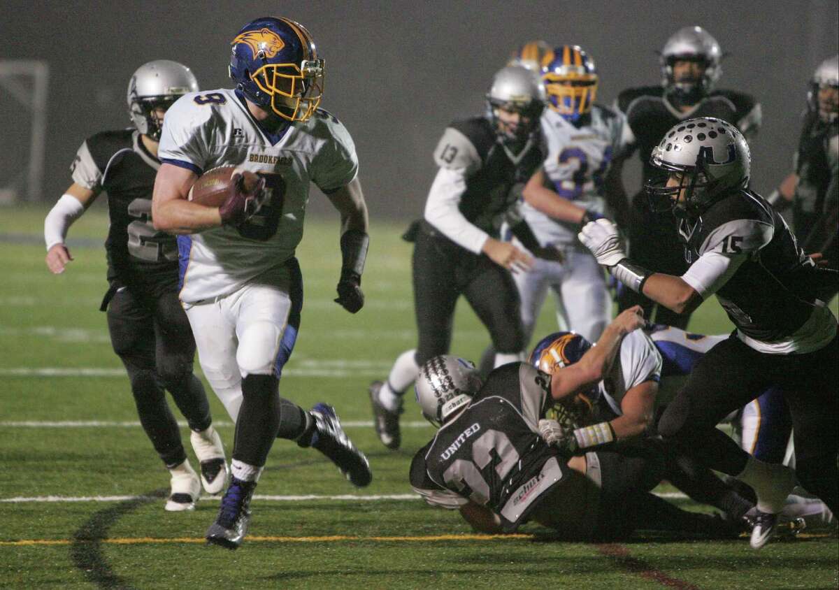 Brookfield's Robert Drysdale breaks away from the ATI United defenders on his way to scoring a first half touchdown in a Class M quarter final football game at Western Connecticut State University in Danbury, Conn. on Dec. 1, 2015. Brookfield won 35-6.