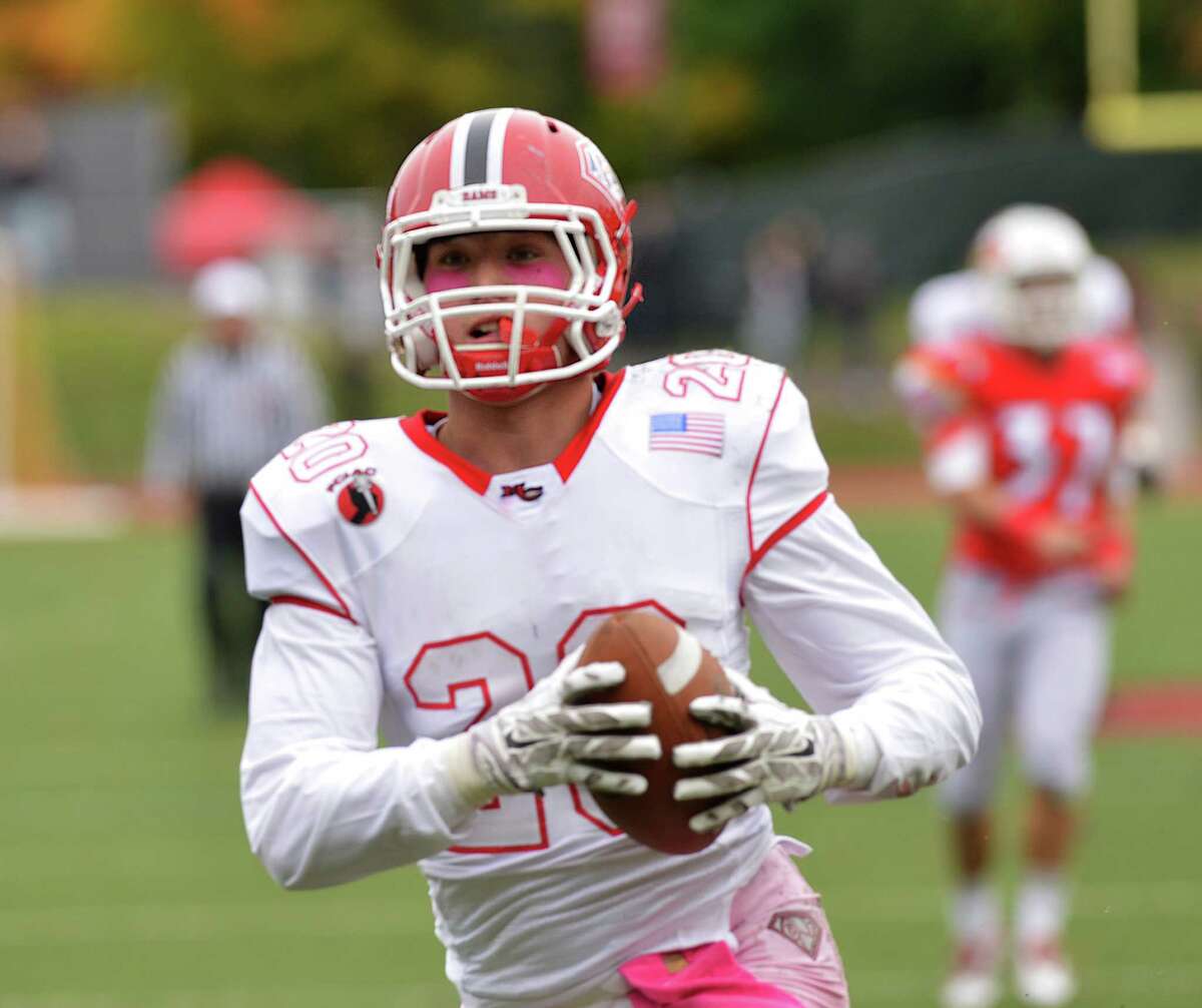 New Canaan receiver Kyle Smith (#20) filled in at safety and runningback Tuesday night at Windsor.