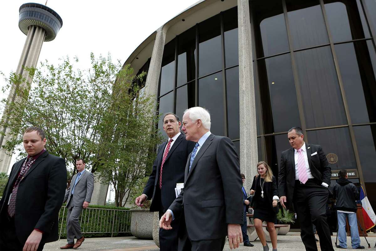 Sen. John Cornyn, center, walks with Sen. John Boozman of Arkansas, center left, following a tour of San Antonio's John H. Wood Federal Courthouse to get a look at the crumbling building and emphasize the need for a new building, on Tuesday, Nov. 24, 2015.