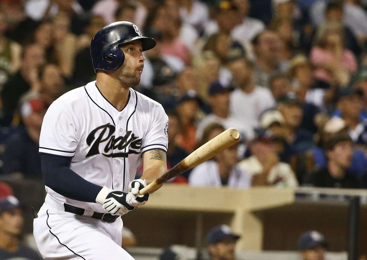 FILE - In this Aug. 17, 2015, file photo, San Diego Padres' Yonder Alonso watches his solo home run against the Atlanta Braves in the eighth inning of a baseball game, in San Diego. A person with knowledge of the deal says the San Diego Padres have traded first baseman Yonder Alonso and reliever Marc Rzepczynski to the Oakland A's for left-hander Drew Pomeranz and minor league pitcher Jose Torres, plus either a player to be named or cash. The person spoke with The Associated Press on Wednesday, Dec. 2, 2015, on condition of anonymity because the trade hadn't been announced.(AP Photo/Lenny Ignelzi, File)