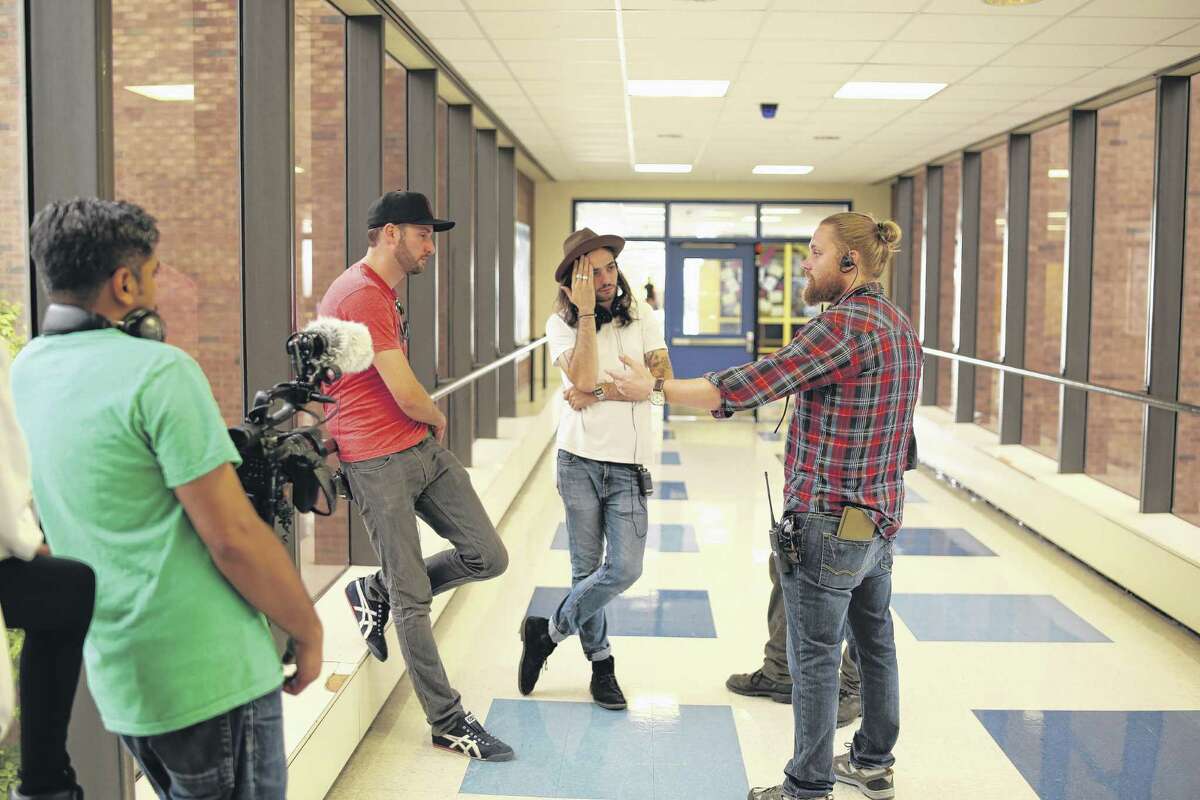 (L to R) Brent Stiefel (producer), Miles Joris-Peyrafitte (Director), Sean Patrick Burke (1st AD/Producer), Bhawin Suchak (in foreground). Discussing a complex dolly shot in the hallway of Albany High School. (Photo courtesy Youth FX) ORG XMIT: MER2015100215230838