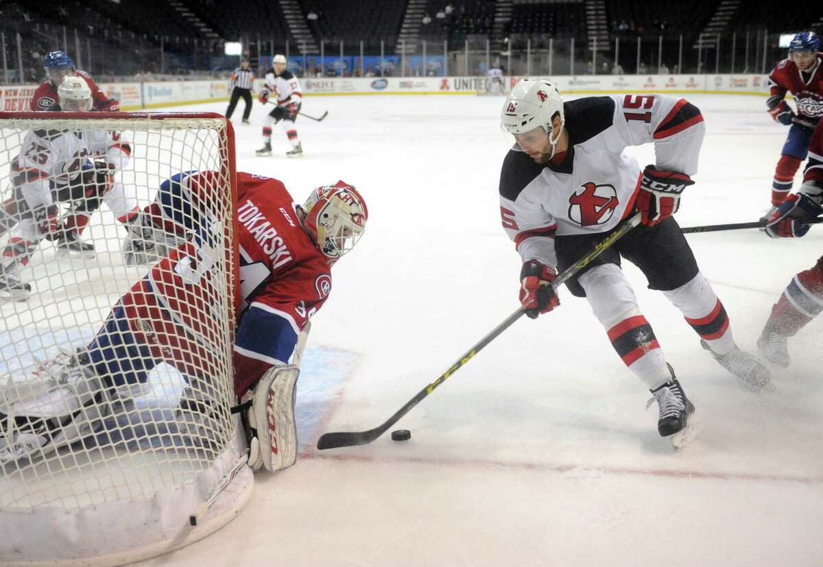 Devils Paul Thompson closes in on St. John's goalie Dustin Tokarski during their hockey game at the Times Union Center on Wedesday Dec. 2, 2015 in Albany, N.Y. (Michael P. Farrell/Times Union)