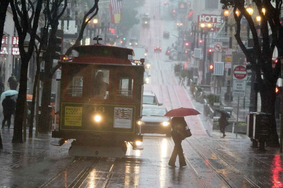 A car drove around a cable car and onto the Powell Street turnaround platform during the rainstorm in San Francisco on Thursday, Dec. 3, 2015.