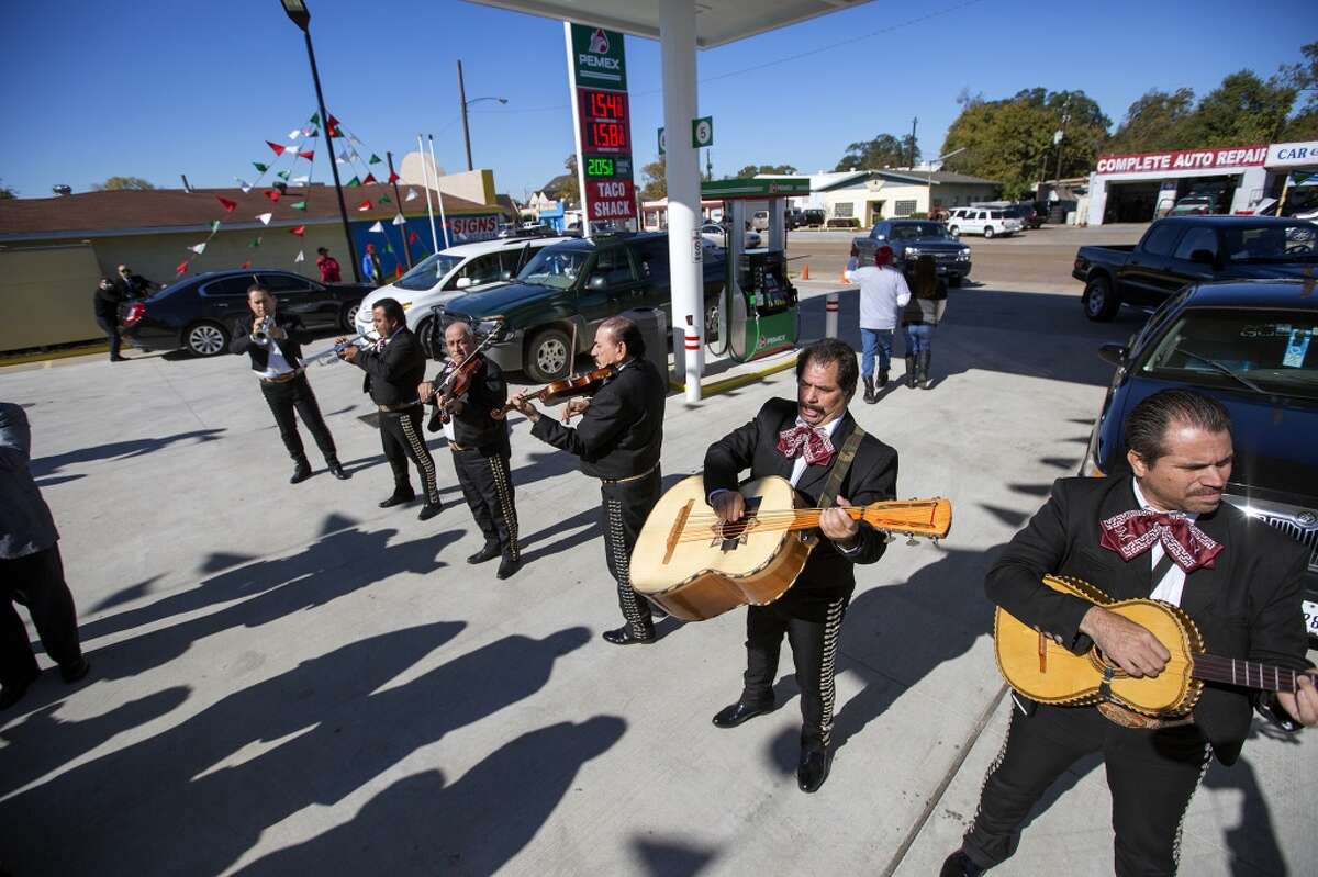 A group of mariachis entertain guests during the grand opening of PEMEX in the 7900 block of Park Place Blvd, Thursday, Dec. 3, 2015, in Houston. The national energy company of Mexico, Pemex, is launching its brand in the U.S. with retail gasoline stations, starting in Houston. (Cody Duty / Houston Chronicle)