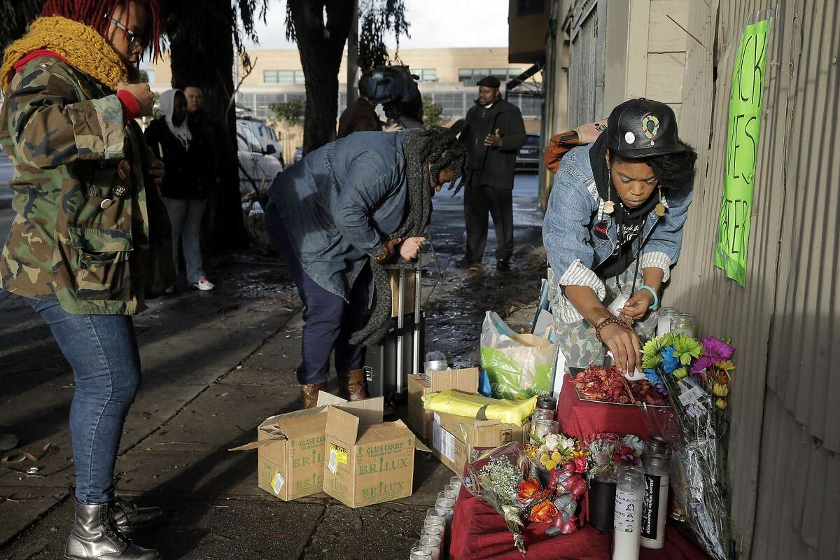 Rheema Calloway, center, Etecia Brown, right, and Ronnishia Johnson, left, build an altar for Mario Woods at the site where he was shot and killed by SFPD on Wednesday. Community members gathered at the site where Mario Woods was shot and killed by San Francisco Police to build an altar in the Bayview district of San Francisco, Calif., on Thursday, December 3, 2015.