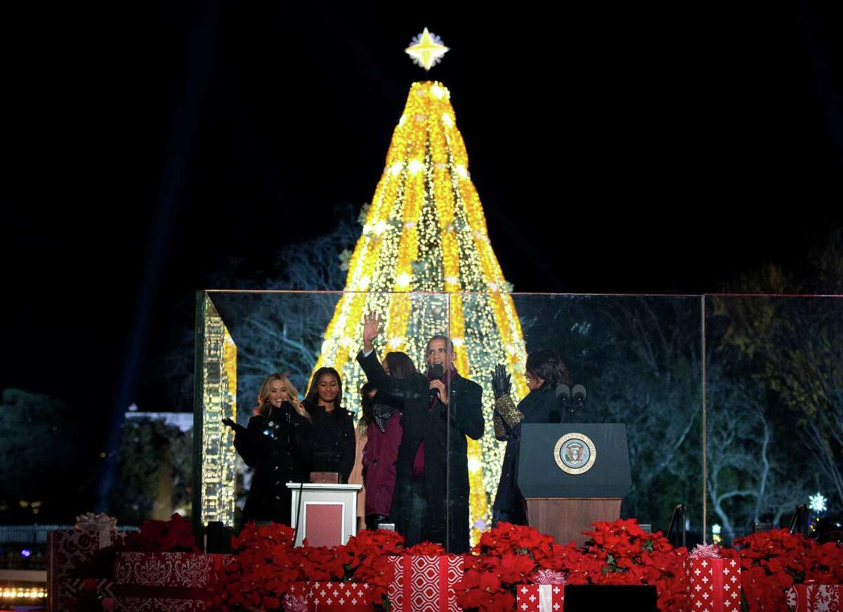 From left, actress Reese Witherspoon, Sasha Obama, first lady Michelle Obama's mother Marian Robinson, Malia Obama, President Barack Obama, and first lady Michelle Obama, react after they light the National Christmas Tree during the National Christmas Tree Lighting ceremony at the Ellipse in Washington, Thursday, Dec. 3, 2015. (AP Photo/Carolyn Kaster) ORG XMIT: DCCK109