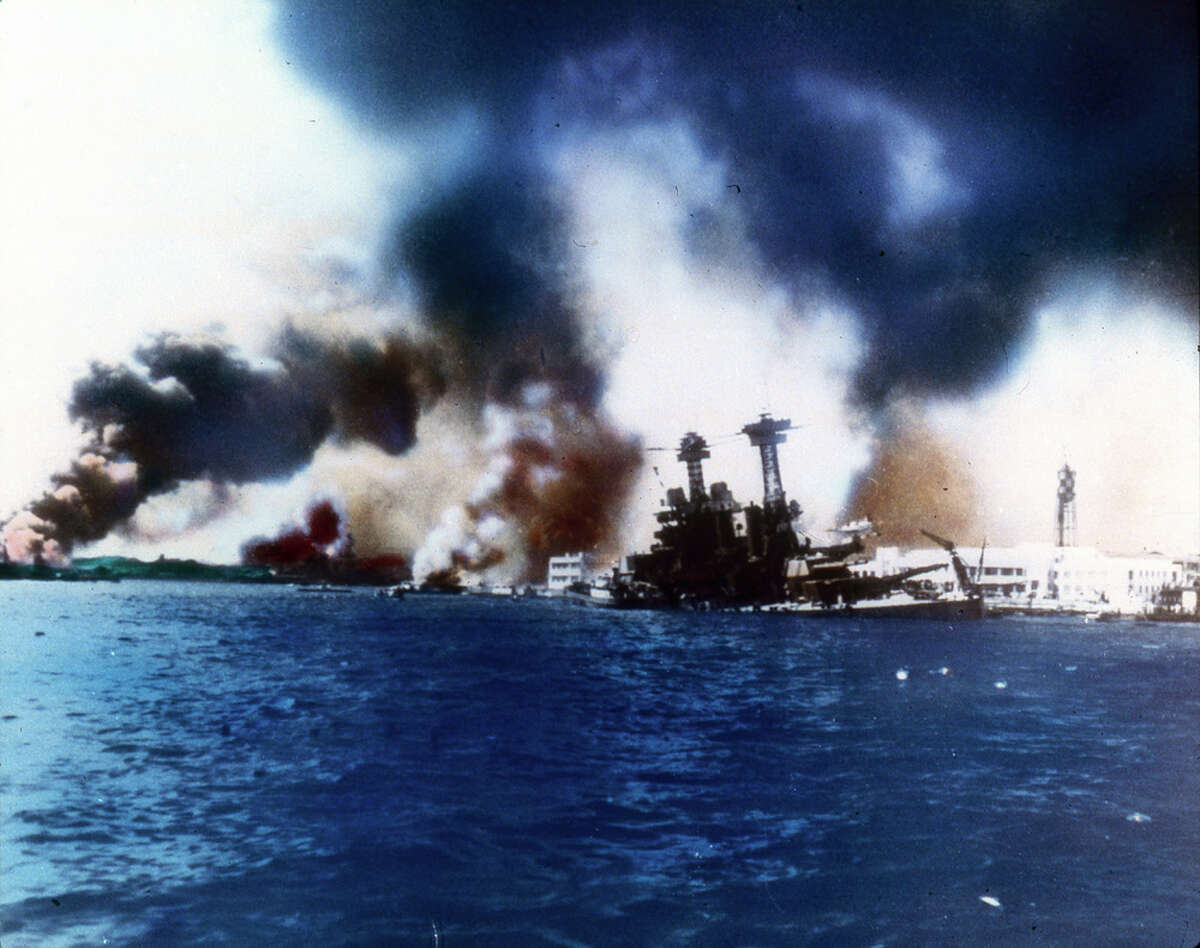 The battleship USS California sinks near Ford Island after the Japanese bombed and torpedoed the ship during the attack on Pearl Harbor, Honolulu, Oahu, Hawaii, December 7, 1941. The destroyer USS Shaw burns in the far left.