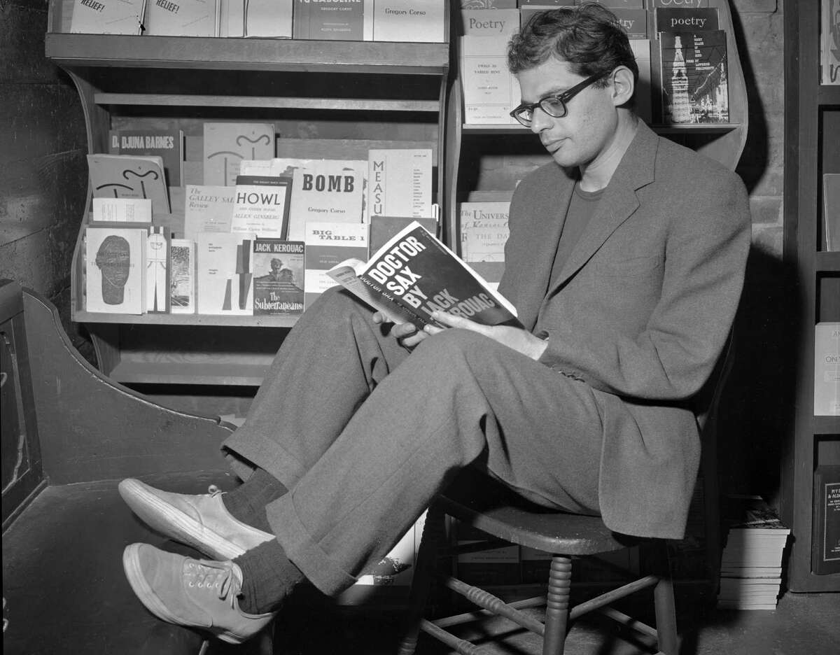 Allen Ginsberg thumbs through a Jack Kerouac work at a San Francisco bookstore in June 1959.