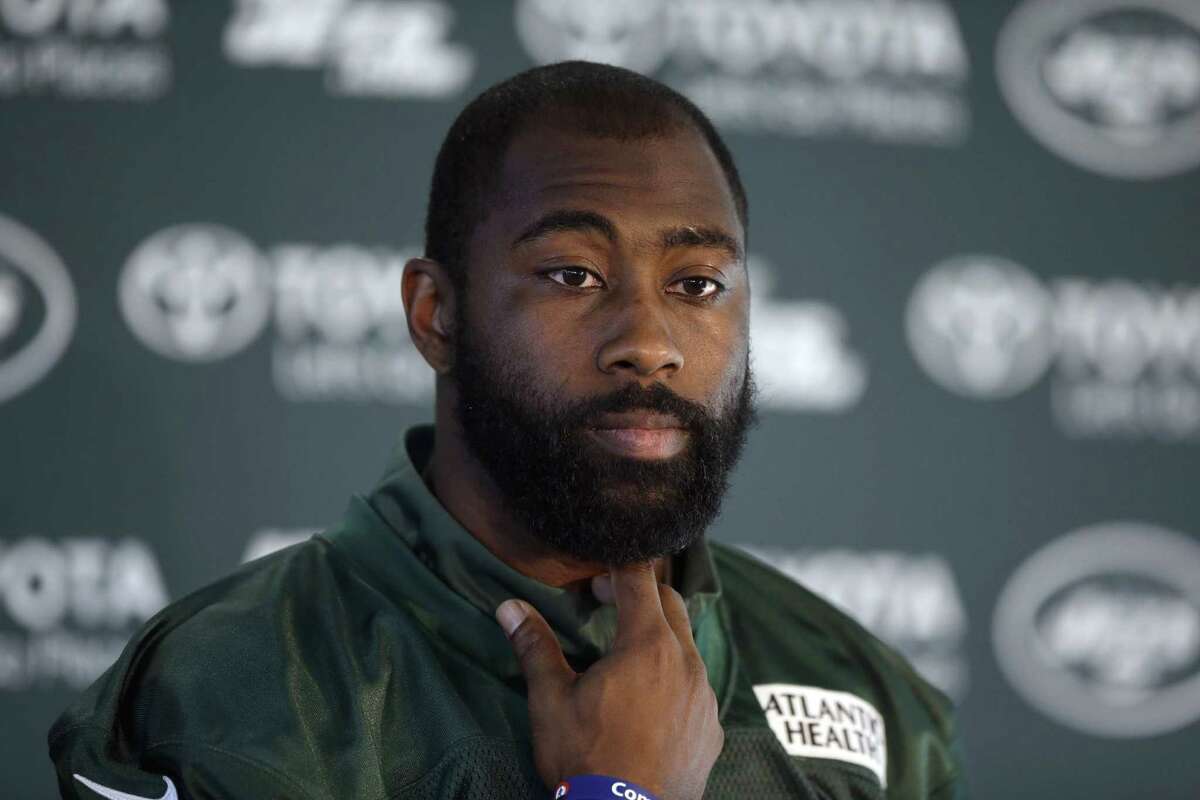 FILE - In this Oct. 2, 2015, file photo, New York Jets cornerback Darrelle Revis gives a press conference after an NFL training session at London Irish training ground in south west London. The Jets are taking on Odell Beckham Jr. without Darrelle Revis. Coach Todd Bowles announced Friday, Dec. 4, 2015, that the star cornerback is officially listed as out for the game Sunday because of a concussion. (AP Photo/Matt Dunham, File)
