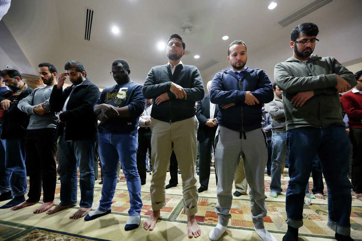 Worshipers offer their prayers for the victims and families of the San Bernardino shooting, Friday, Dec. 4, 2015, at the Islamic Society of Greater Houston.