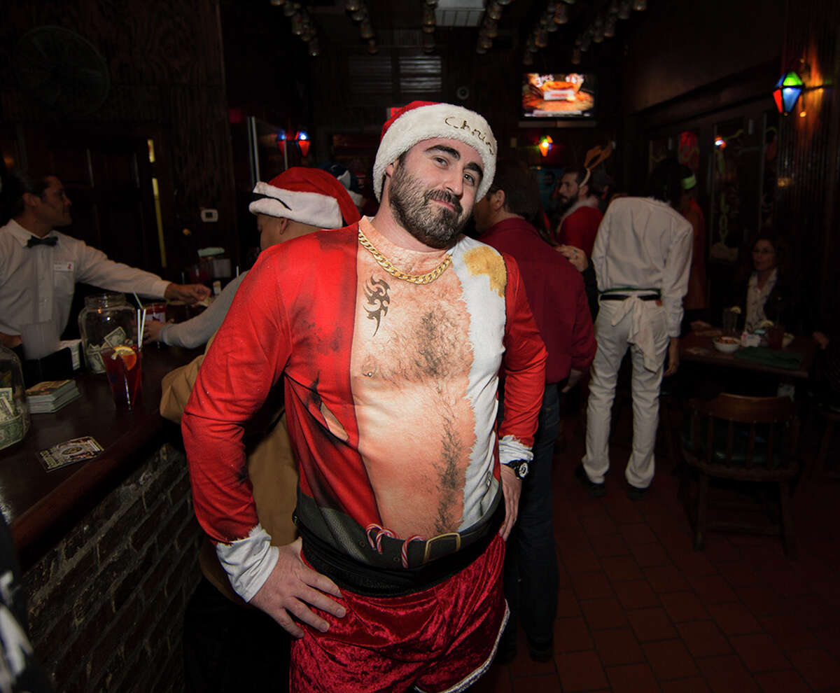San Antonians put on their best holiday garb and took a running tour of downtown San Antonio bars Dec. 4, 2015 in the first official First Friday Pub Run.