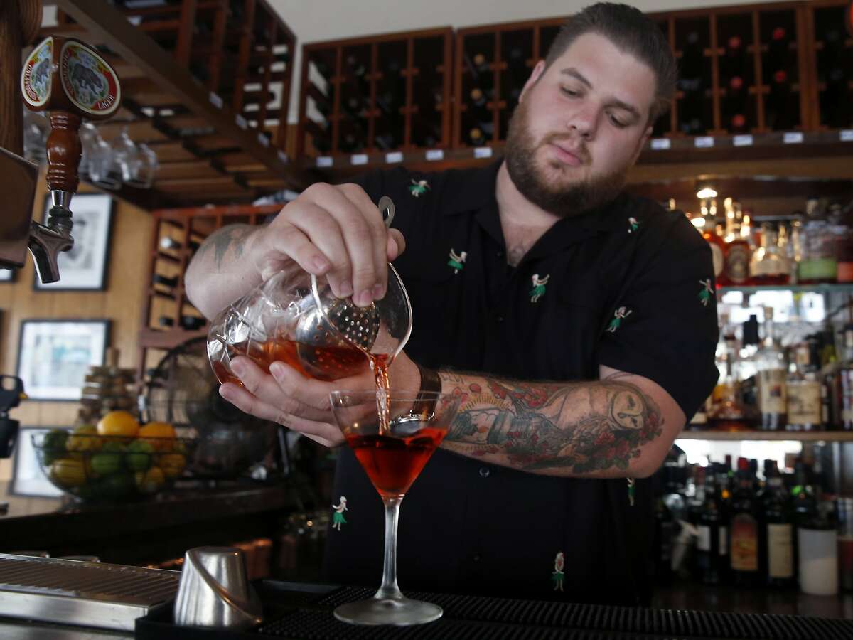 Kevin Correnti pours an original Negoni cocktail at his Trattoria Contadina restaurant in San Francisco, Calif. on Saturday, Dec. 5, 2015.