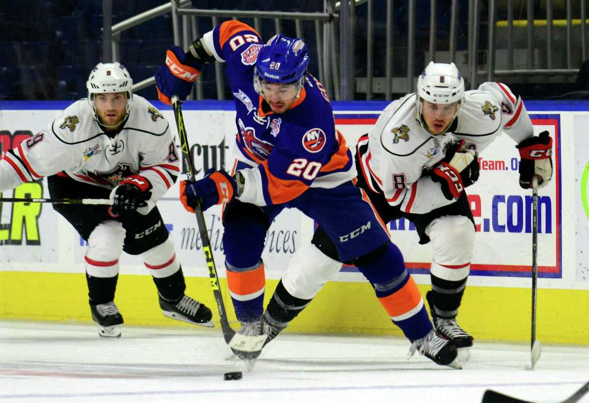 Sound Tigers Jared Gomes drives the puck as Portland's Rocco Grimaldi, left, and Brent Regner, right, follow during AHL hockey action at the Webster Bank Arena in Bridgeport, Conn. on Saturday Dec. 5, 2015.