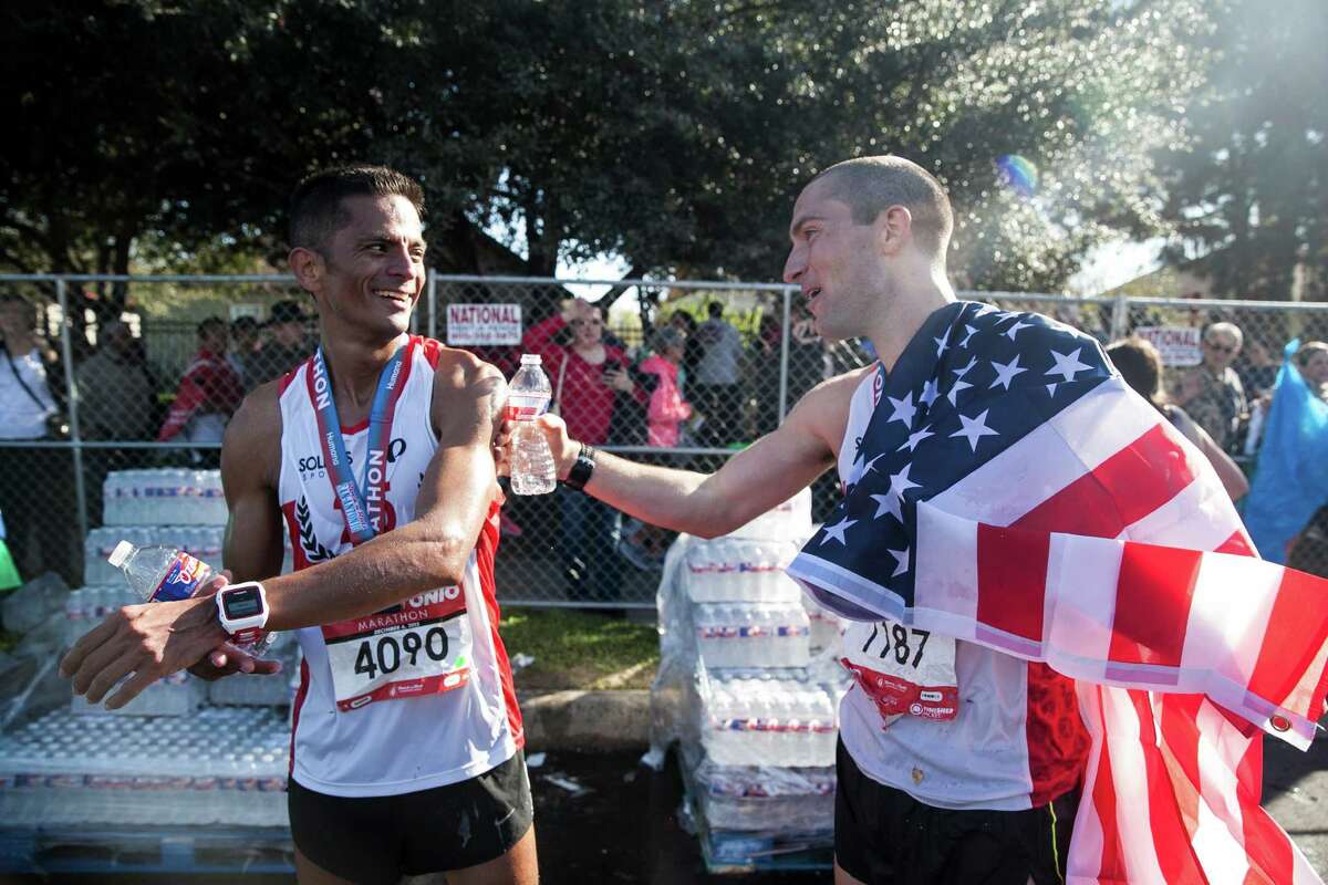 Mark Greene congratulates his friend Ricardo Carrillo, after finishing the full marathon division Sunday Dec. 6, 2015 during the Rock 'n' Roll San Antonio Marathon at the Alamodome. Greene is a San Antonio native and this is his second Rcok 'n' Roll marathon that he has participated in.