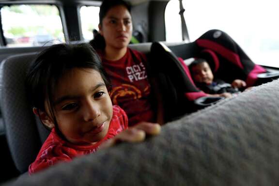 Aura Velasco, daughter Karen Perez and son Eliazar Velasquez catch a ride to the market on the Magic Bus.