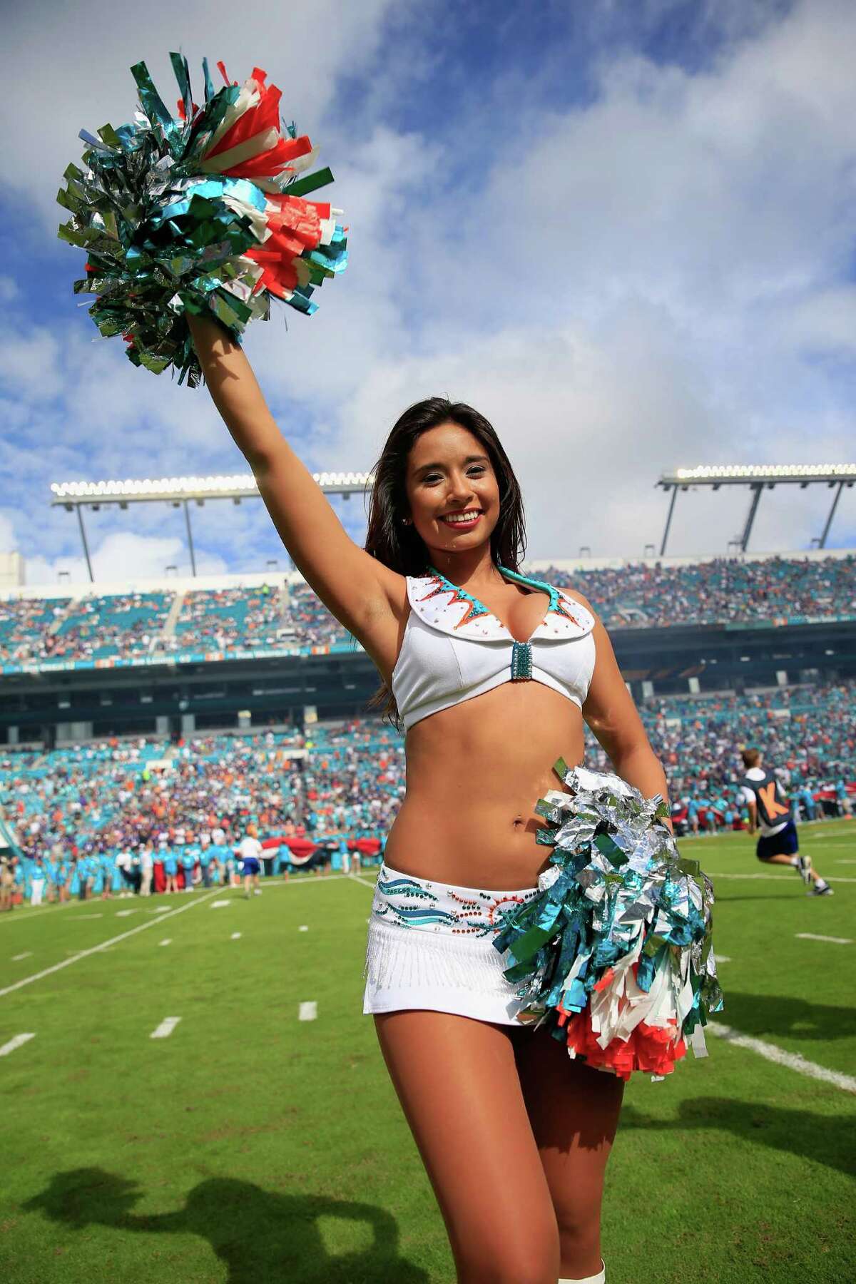 MIAMI GARDENS, FL - DECEMBER 06: A Miami Dolphins cheerleader performs during a game between the Miami Dolphins and the Baltimore Ravens at Sun Life Stadium on December 6, 2015 in Miami Gardens, Florida.