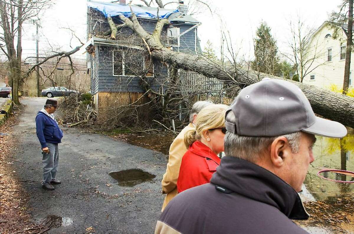 Federal and state officials tour the city assessing the damage from the storm earlier this month in Stamford, Conn. on Wednesday March, 31, 2010. They stop by a house on High Ridge Road where a tree fell during the storm