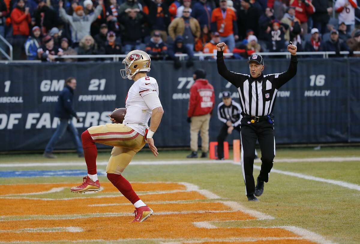 NFL back judge Tony Steratore (112) signals a touchdown as San Francisco 49ers quarterback Blaine Gabbert (2) runs to the end zone during the second half of an NFL football game between the Chicago Bears and the San Francisco 49ers, Sunday, Dec. 6, 2015, in Chicago. (AP Photo/Charles Rex Arbogast)
