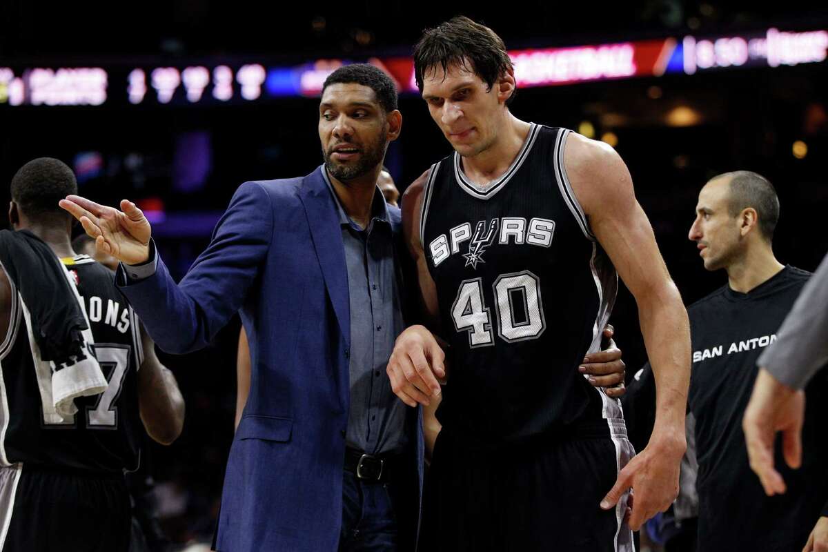 Spurs’ Tim Duncan, left, talks things over with Boban Marjanovic during the second half against the Philadelphia 76ers.