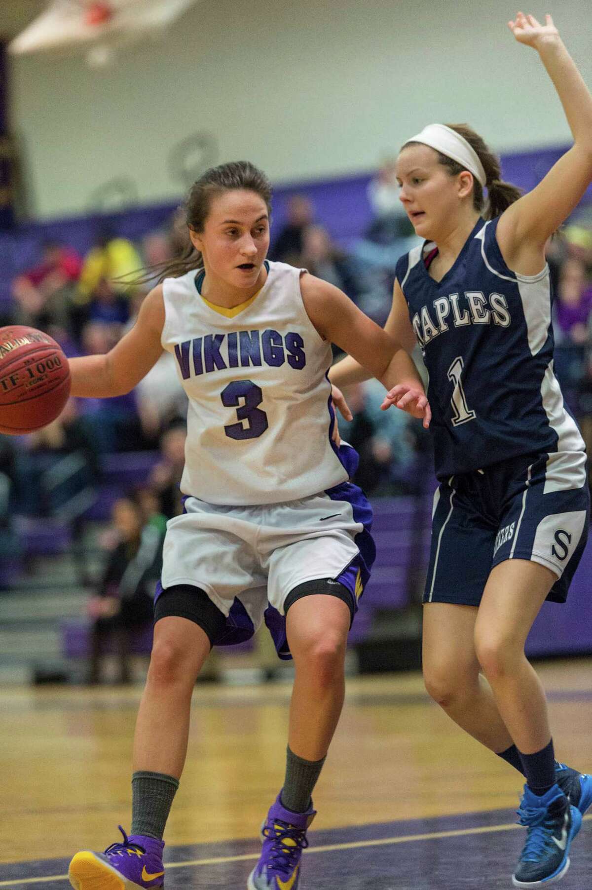 Westhill High School's Edona Thaqi drives toward the basket as Staples High School's Rachel Seideman tries to stop her during a girls basketball game against played at Westhill High School Stamford, CT on Friday, December 12th, 2014