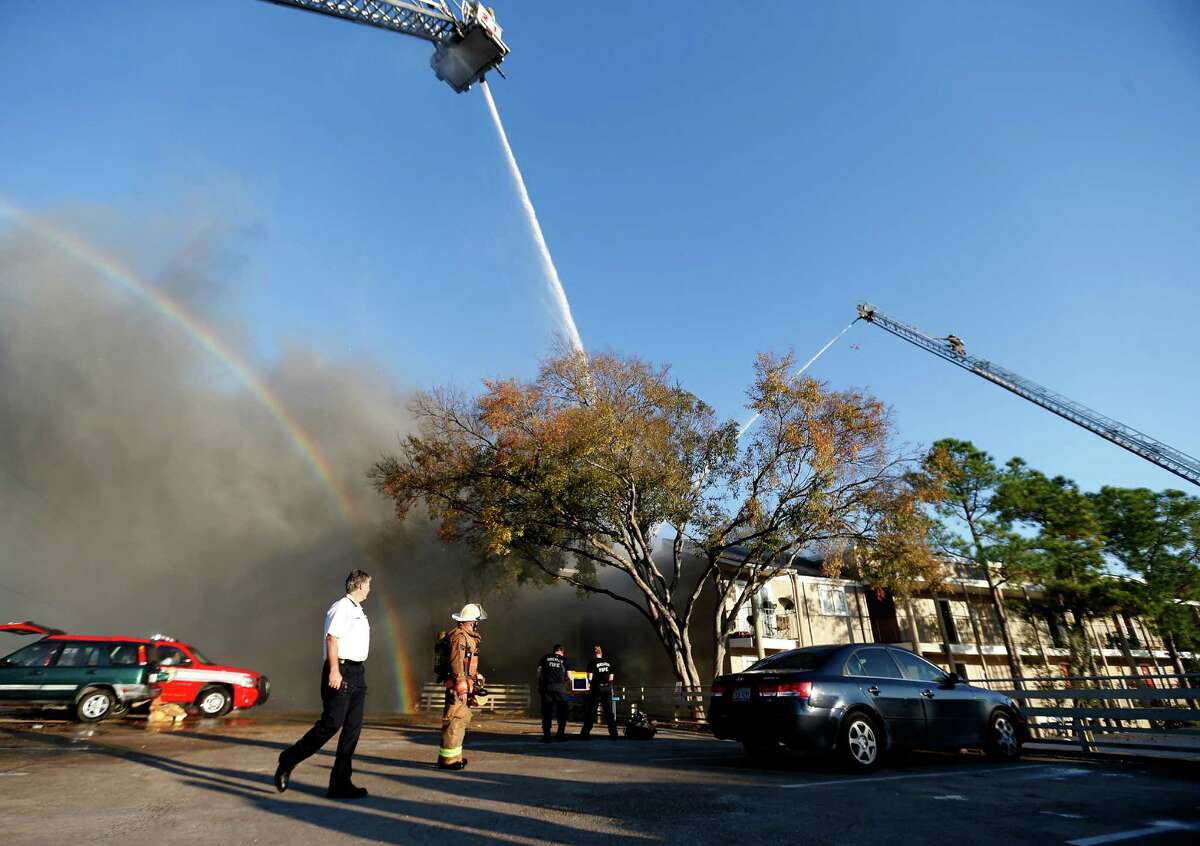 Houston firefighters battle a four-alarm blaze in the 6400 block of Westheimer on Tuesday.