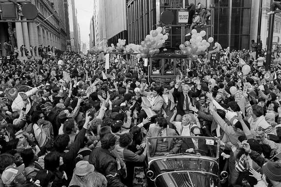 Forty-Niners coach Bill Walsh, right, rides with team owner Eddie DeBartolo and Mayor Dianne Feinstein down San Francisco's Market Street, Jan. 25, 1982. Huge crowds greeted the team that gave the city its first world championship in a major sport with their Super Bowl win Sunday. (AP Photo)