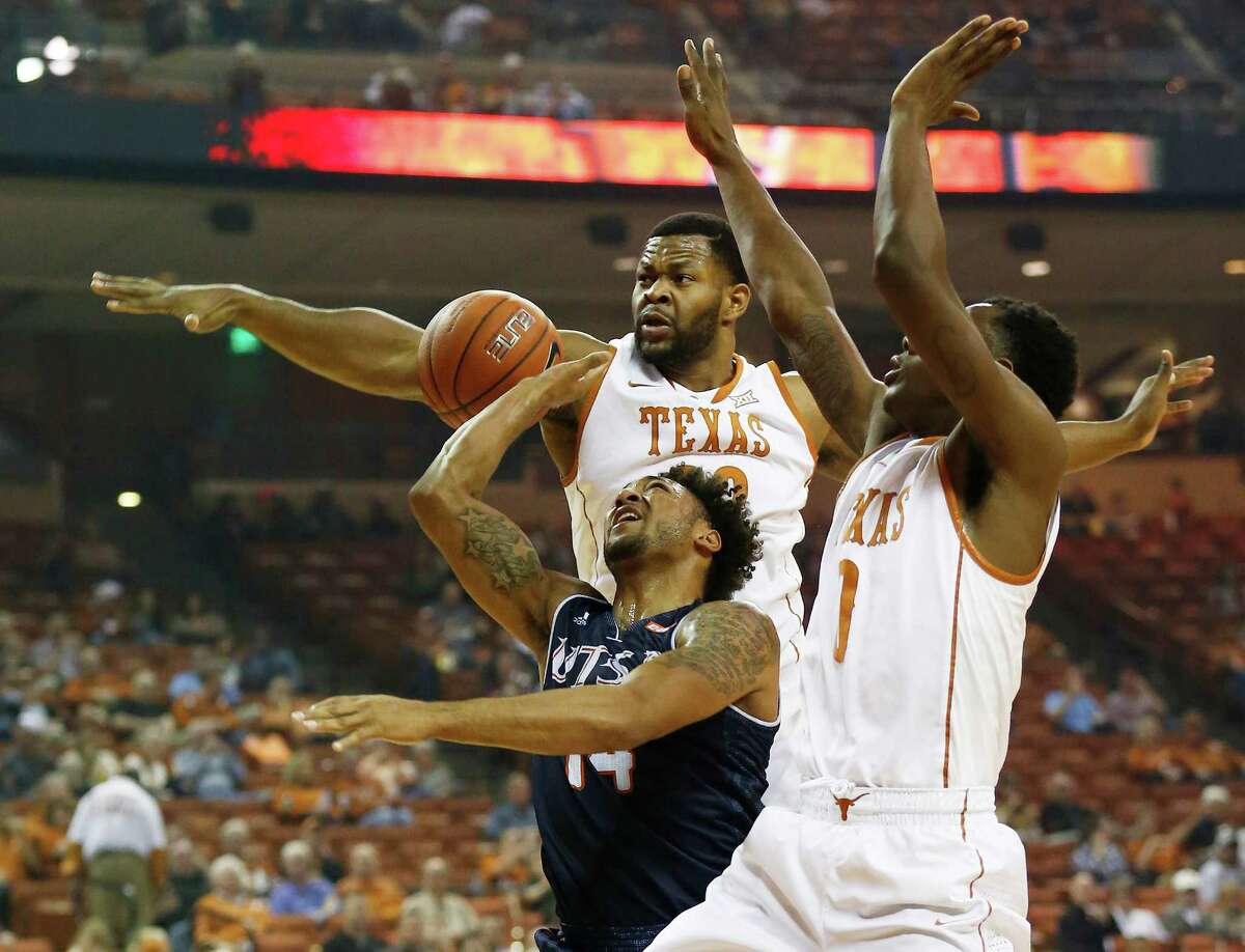 UTSA's Ryan Bowie (14) gets a shot blocked by Texas' Shaquille Cleare (32) and Isaiah Taylor (01) in Austin on Tuesday, Dec. 8, 2015. (Kin Man Hui/San Antonio Express-News)