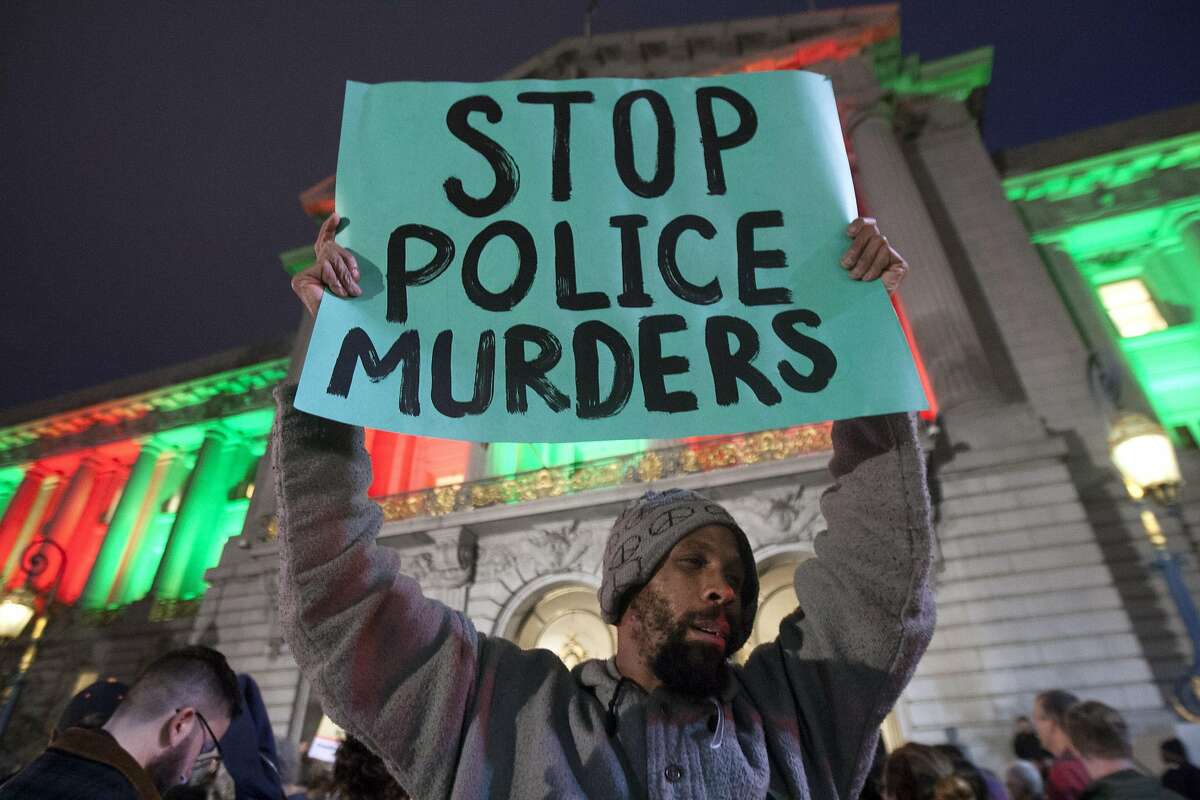 Hundreds of people protest outside San Francisco City Hall, Wednesday, Dec. 9, 2015, in San Francisco, Calif. The S.F. Police Commission met inside City Hall and talked about the possibility of equipping police officers with Tasers following the fatal shooting of Mario Woods. It's a proposal that was turned down twice by the commission in recent years. Woods' case has brought the proposal back. Woods was shot and killed by police officers after police say Woods was armed with a knife and walked toward officers.