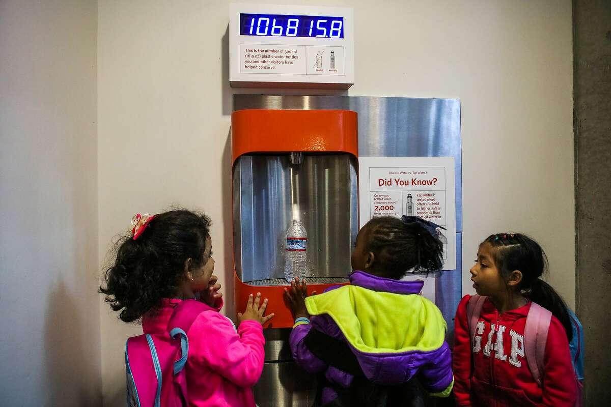 Leah Athyzsni (left) and Shamira Dickerson (center) refill a water bottle while visiting the California Academy of Sciences, in San Francisco, California on Wednesday, December 9, 2015.
