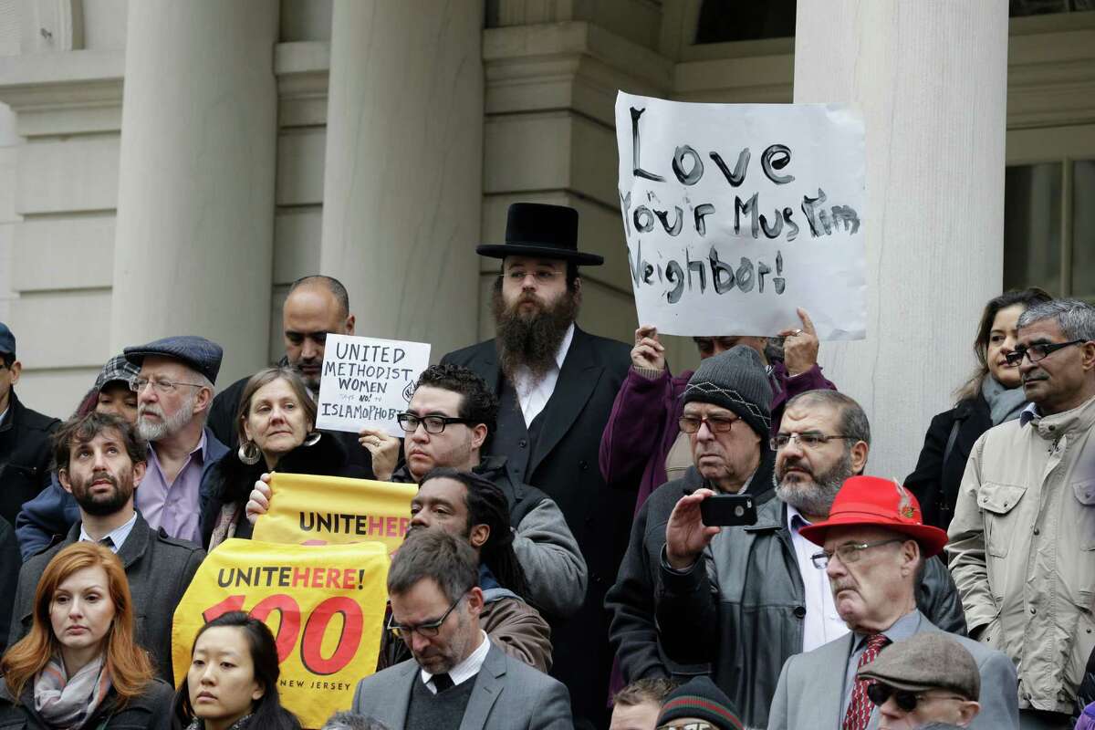 People stand on the steps of New York's City Hall during an interfaith rally in response to Republican presidential candidate Donald Trump's call to block Muslims from entering the United States, Wednesday, Dec. 9, 2015, in New York. (AP Photo/Mary Altaffer) ORG XMIT: NYMA105