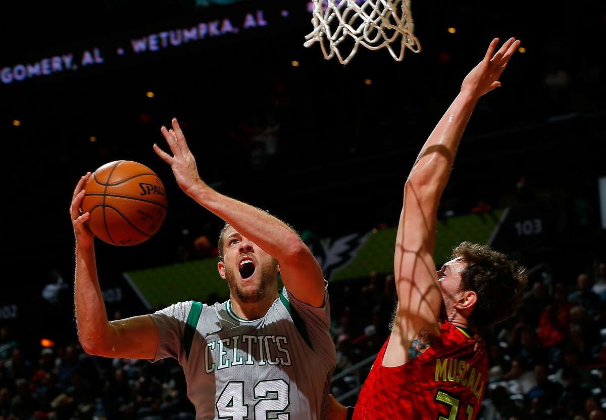 David Lee #42 of the Boston Celtics drives against Mike Muscala #31 of the Atlanta Hawks at Philips Arena on November 24, 2015 in Atlanta, Georgia.