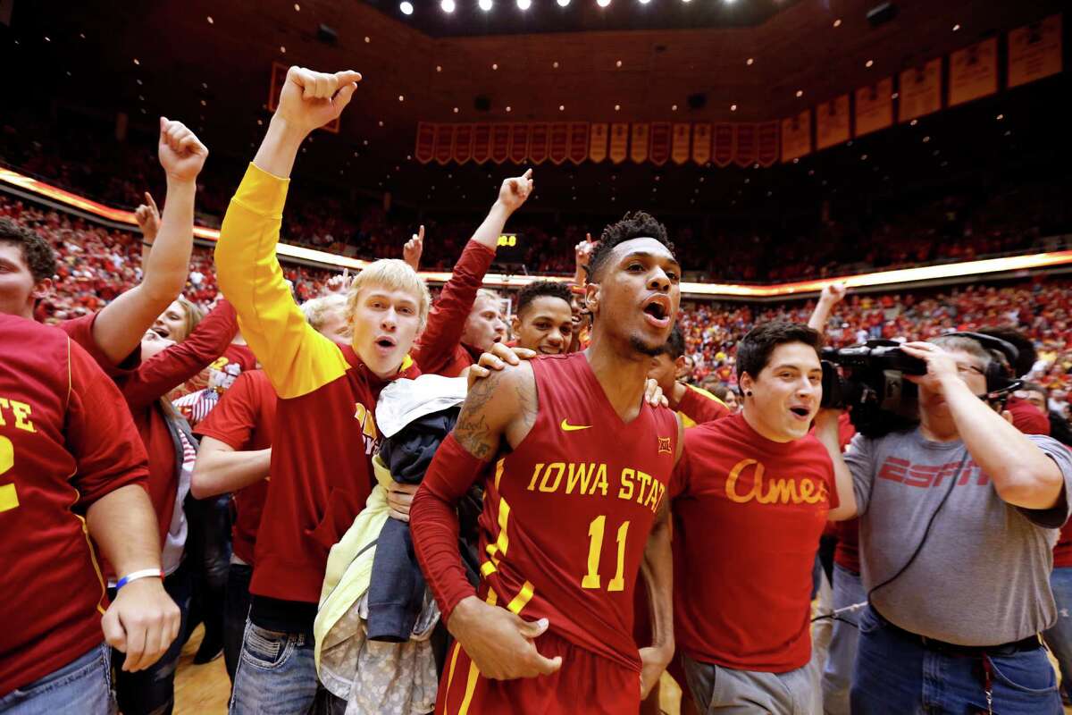 Iowa State's ﻿Monte Morris (11) ﻿celebrates with fans after he sank the winning basket to defeat Iowa 83-82 on Thursday in Ames, Iowa.﻿