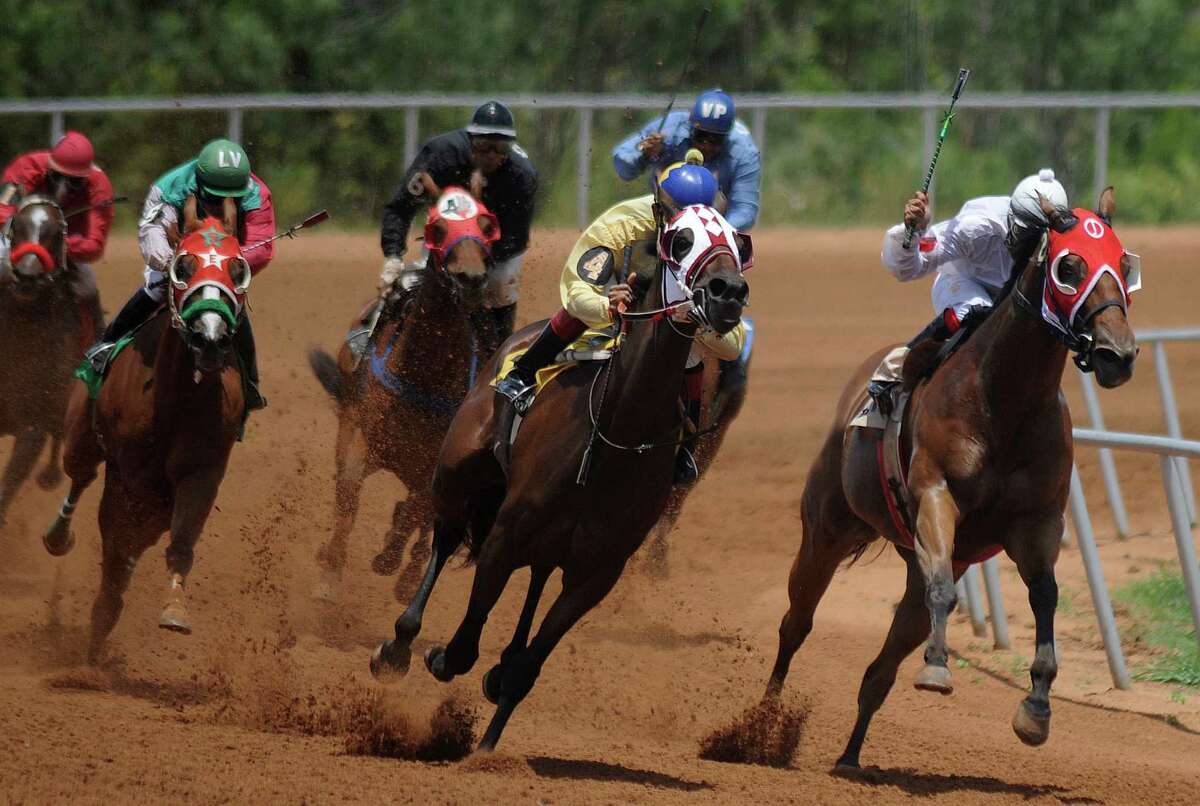 Riders and quarter horses come around the turn at the Gillespie County Fairgrounds in Fredericksburg. Texas’ horse racing industry is fighting for its life and being thwarted by legislative leaders.