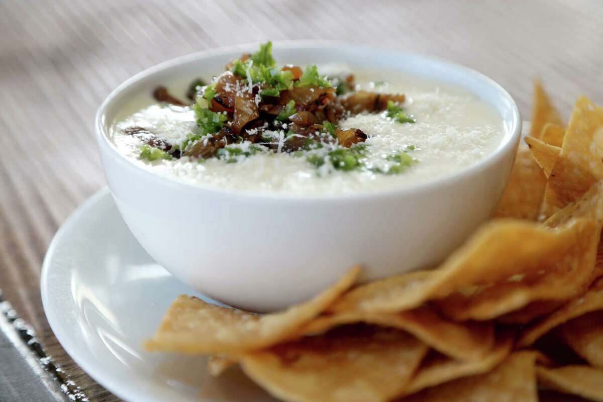 Food Network Magazine's current issue highlights Houston's culinary wealth in a pre-Super Bowl feature. Shown: House queso with charred onions and fresh cilantro at Eight Row Flint.