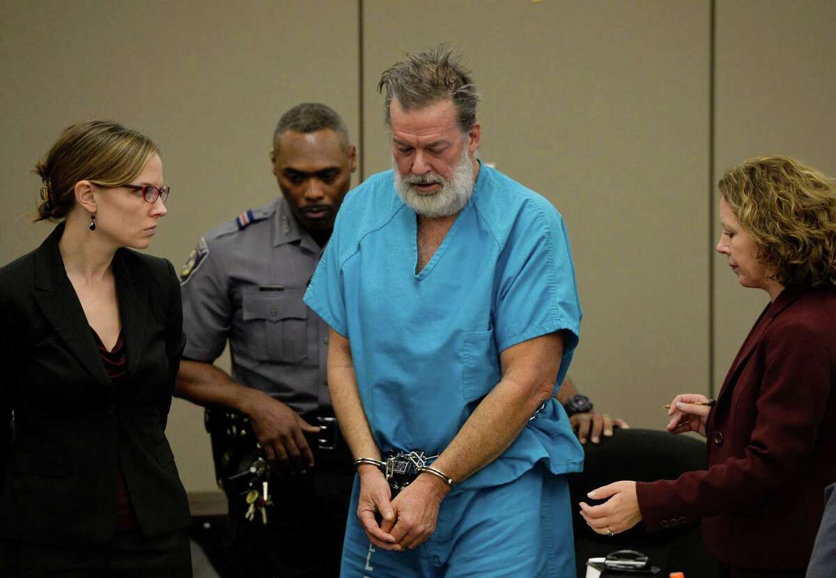 Robert Lewis Dear is led out of court by his lawyers and a deputy following his court appearance last week. He is accused of killing three people and wounding nine others at a Colorado Springs Planned Parenthood clinic. A reader says it is wrong to blame the killings on anti-abortion comments by politicians.