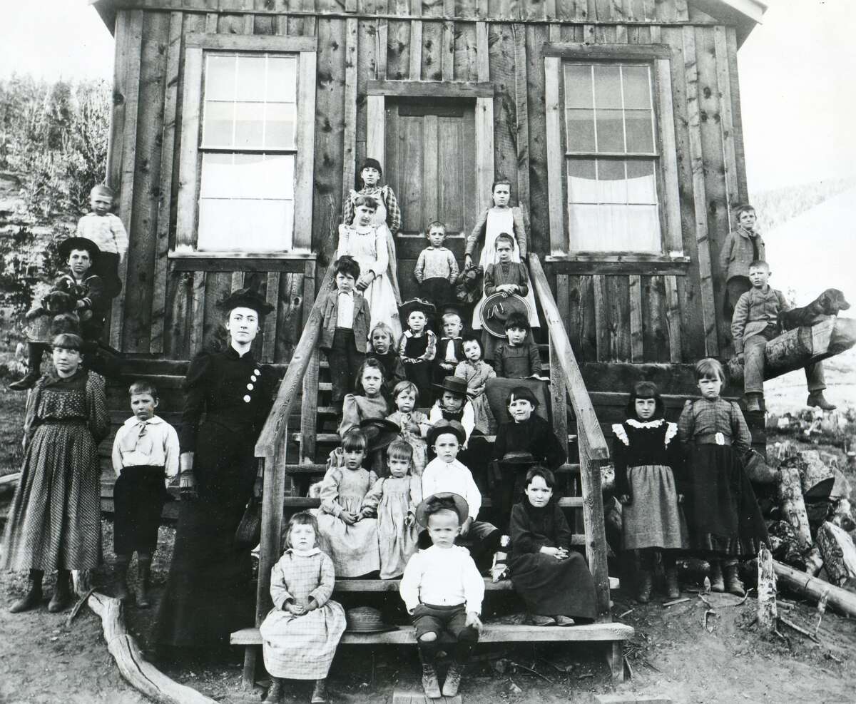 Blanche Lamont poses with her pupils outside her one-room schoolhouse in Montana, October 1893. She was murdered two years later.
