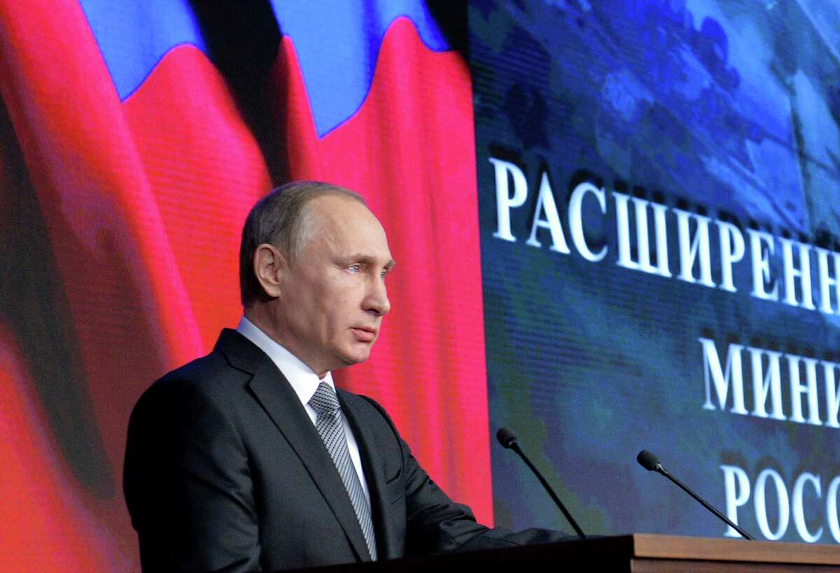Russian President Vladimir Putin delivers his speech during a meeting with top military officials in Moscow, Russia, Friday, Dec. 11, 2015. Putin said the Russian military action helped change the situation in Syria, supporting the Syrian army offensive. (Alexei Druzhinin/Sputnik, Kremlin Pool Photo via AP)