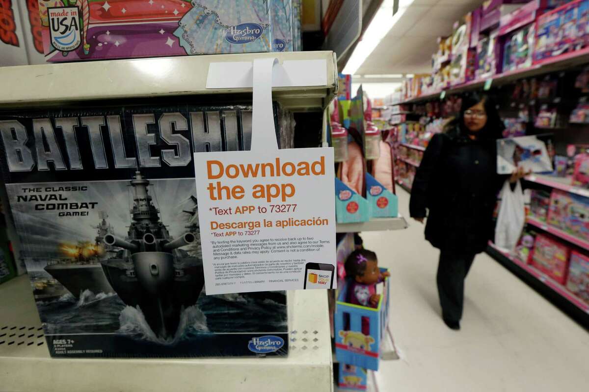 A sign for a shopping application is placed at the toys section in Kmart, in New York. Mobile shopping accounts for about 10 percent of online sales this season, but it made up half of all online traffic during Black Friday weekend, according to IBM Benchmark, which did not give dollar amounts.