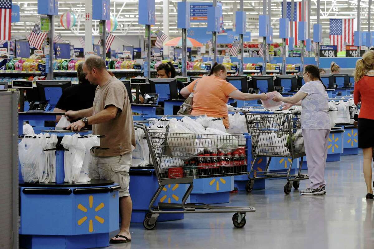 Shoppers check out at a Wal-Mart Supercenter in Springdale, Ark. U.S. retail sales rose 0.2 percent to $448 billion last month, the Commerce Department said.﻿