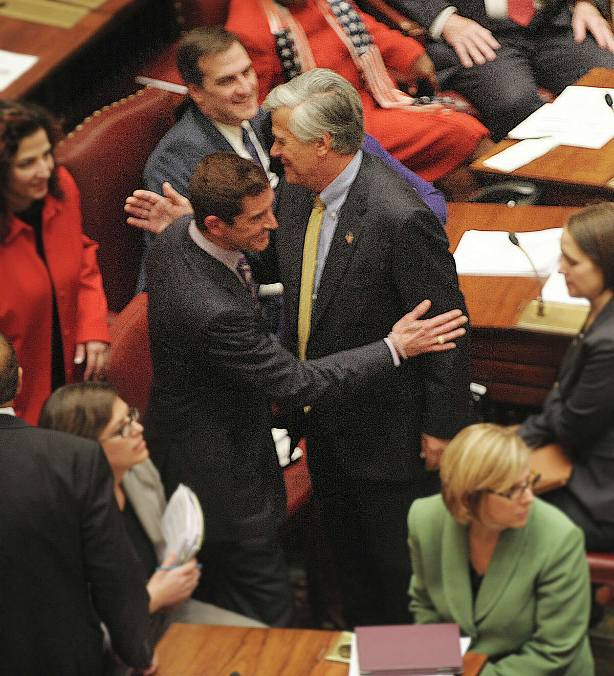 Newly elected co-leaders of the Senate, Senator Jeffrey Klein, left, and Senator Dean Skelos give each other a pat on the shoulder as they pass on the floor of the Senate on Wednesday, Jan. 9, 2013 in Albany, NY. (Paul Buckowski / Times Union)