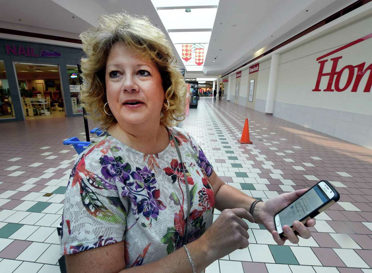 Linda Matuszak holds her ever present smart phone with the Shopkick app on board at Wilton Mall Friday Dec. 11, 2015 in Wilton, N.Y. (Skip Dickstein/Times Union)