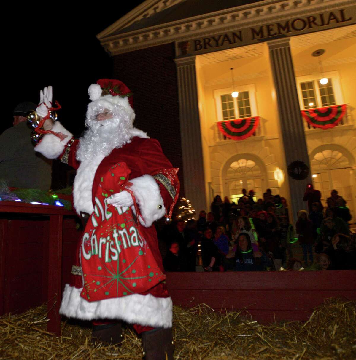 Santa arrives in a horse-drawn hay wagon for Washington's "Holiday in the Depot", on Friday night, December 11, 2015, in Washington, Conn.