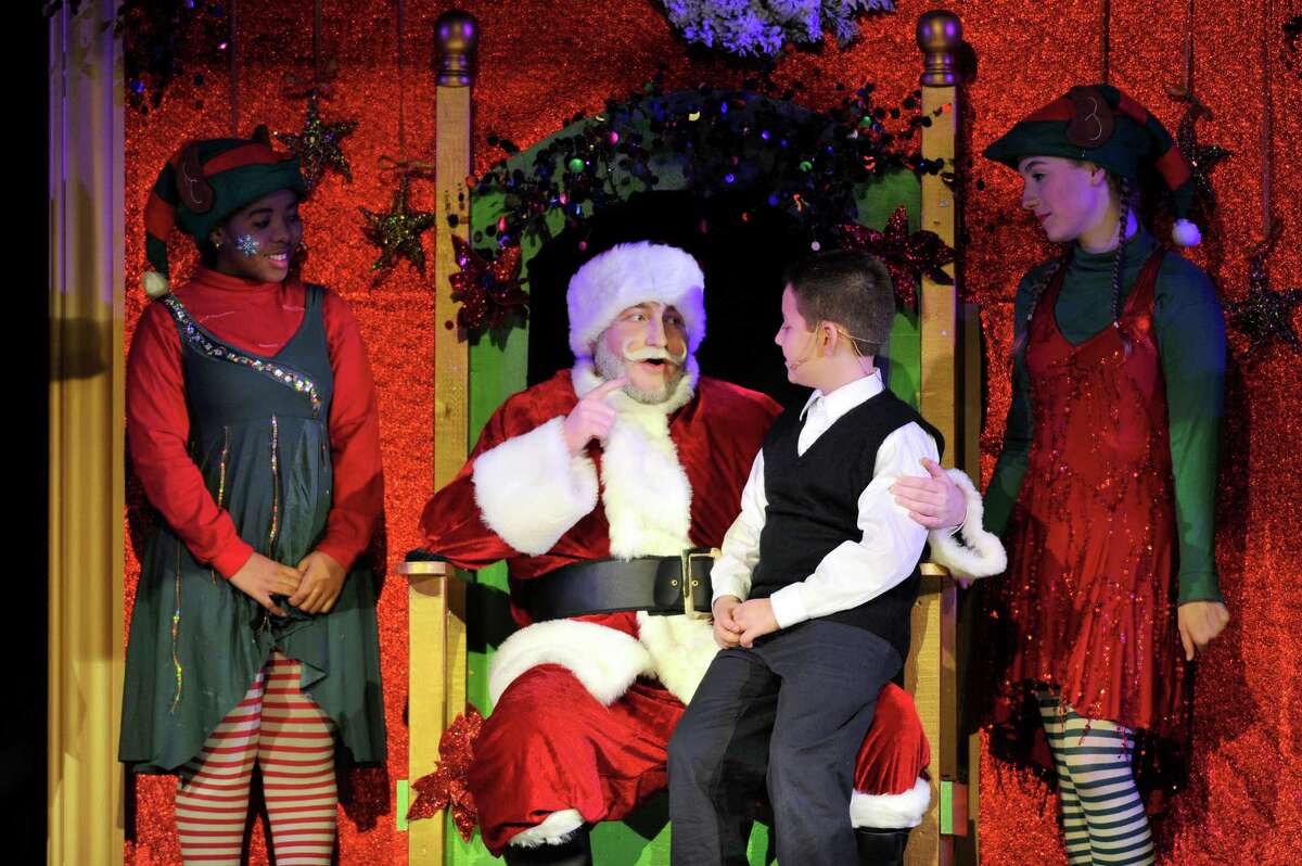 Kris Kringle, played by Patrick Hayes, promises Jimmy, played by Sean Hugh Keeney, a Christmas present during the Trinity Catholic High School Crusader Players production of Miracle on 34th St. on Saturday, Dec. 12, 2015.