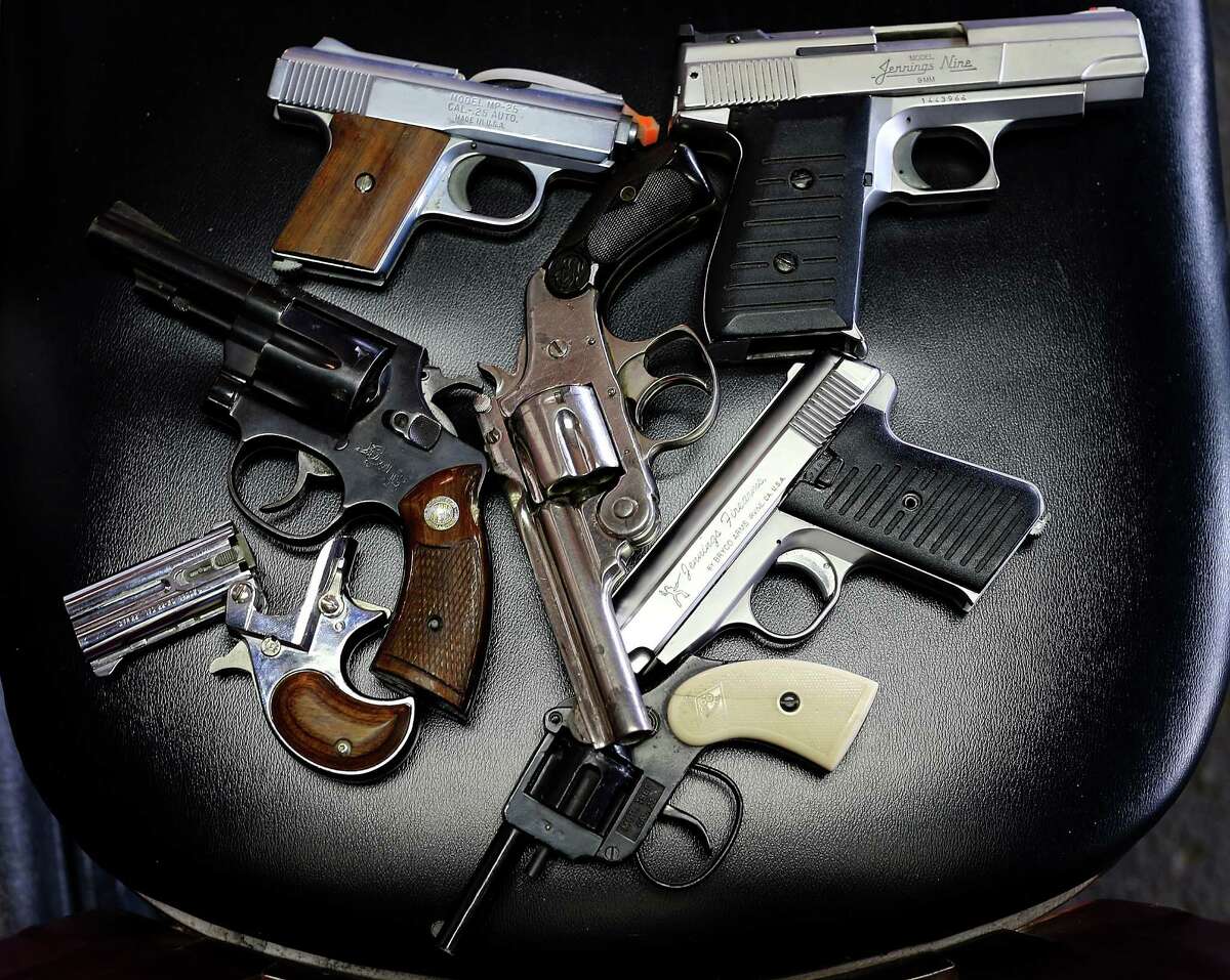 A detail view of pistols that were turned in during a gun buyback program in Dallas. ﻿