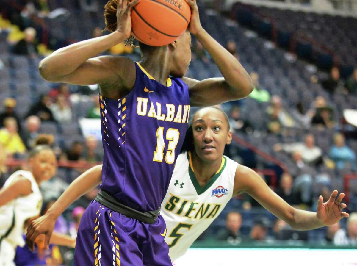 UAlbany's #13 Bose Aiyalogbe, left, is covered by Siena's #5 Jackie Benitez during Saturday's game at the Times Union Center Dec. 12, 2015 in Albany, NY. (John Carl D'Annibale / Times Union)