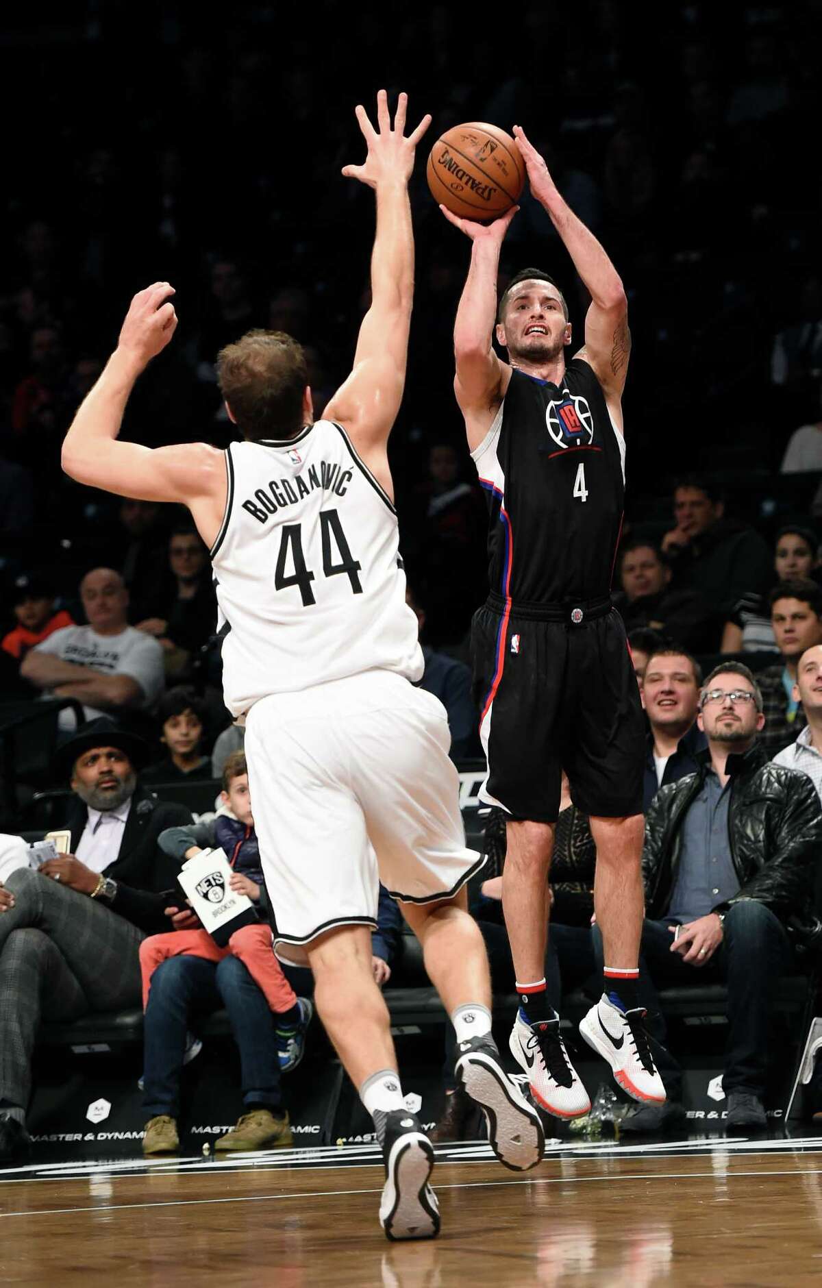 Los Angeles Clippers guard J.J. Redick (4) takes aim for the basket over Brooklyn Nets guard Bojan Bogdanovic (44) during the first half of an NBA basketball game on Saturday, Dec. 12, 2015, in New York. (AP Photo/Kathy Kmonicek)