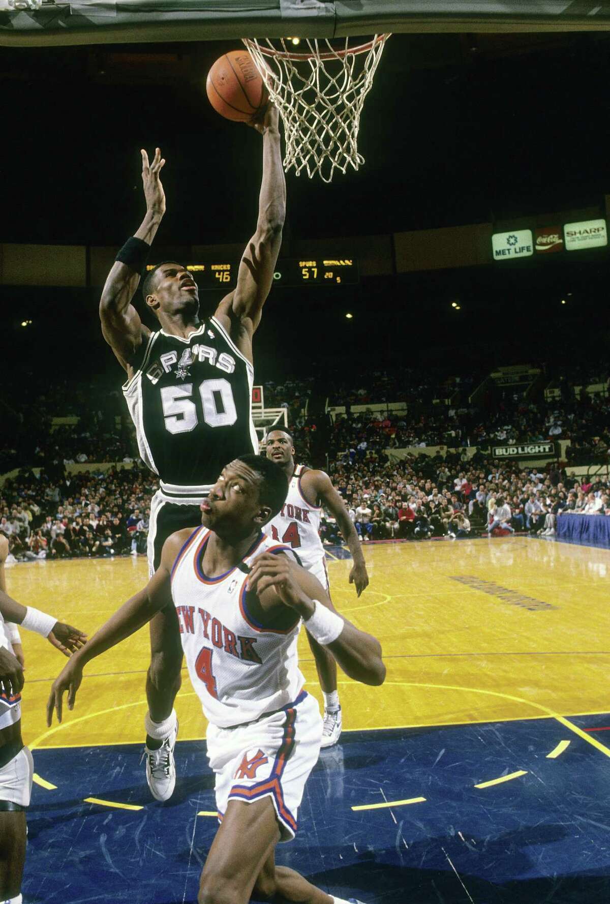 David Robinson of the San Antonio Spurs shoots over Anthony Bonner of the New York Knicks during a mid-circa 1990s game at Madison Square Garden in New York. Robinson played for the Spurs from 1989-03.