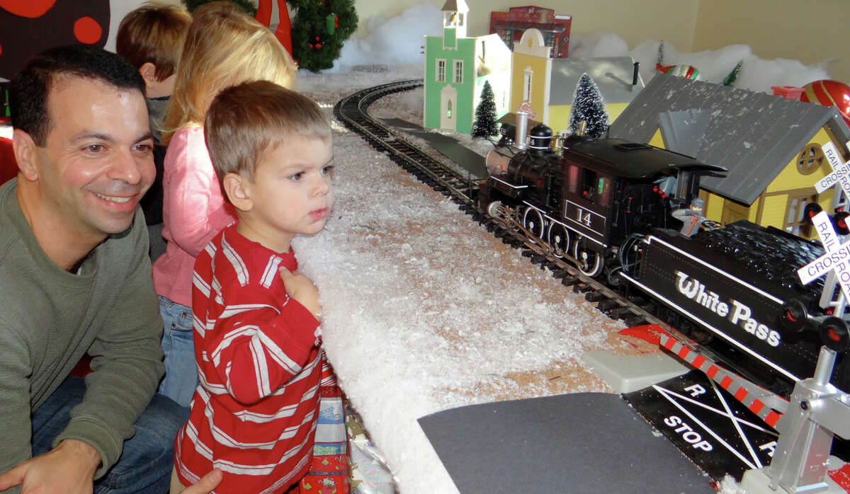 Michael Durbano and son, Matthew, 2, watch the "Polar Express" model train pass by at "A Visit to Santa's House."