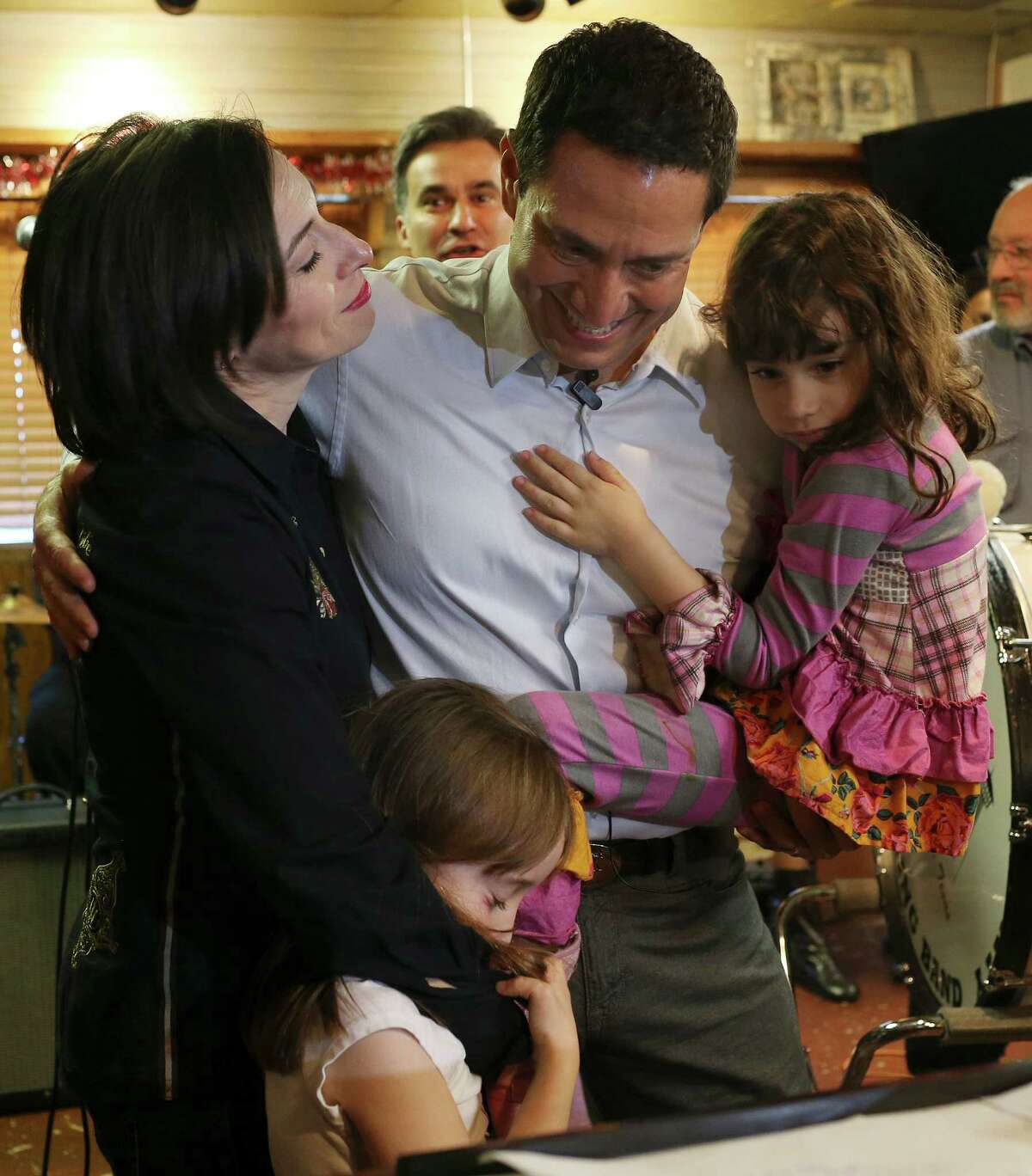 Surrounded by family, Texas State Representative Trey Martinez Fischer announces his candidacy for Texas Senate District District 26 at Henry's Puffy Tacos, Sunday, Dec. 13, 2015. For a second time, Martinez Fischer will face off with Sen. Jose Menendez for the seat vacated by Leticia Van De Putte. Menendez won the special election for the vacated seat in February of this year. With him is his wife, Elizabeth Marie and their two daughters, Francesca, lower left, and Camila.